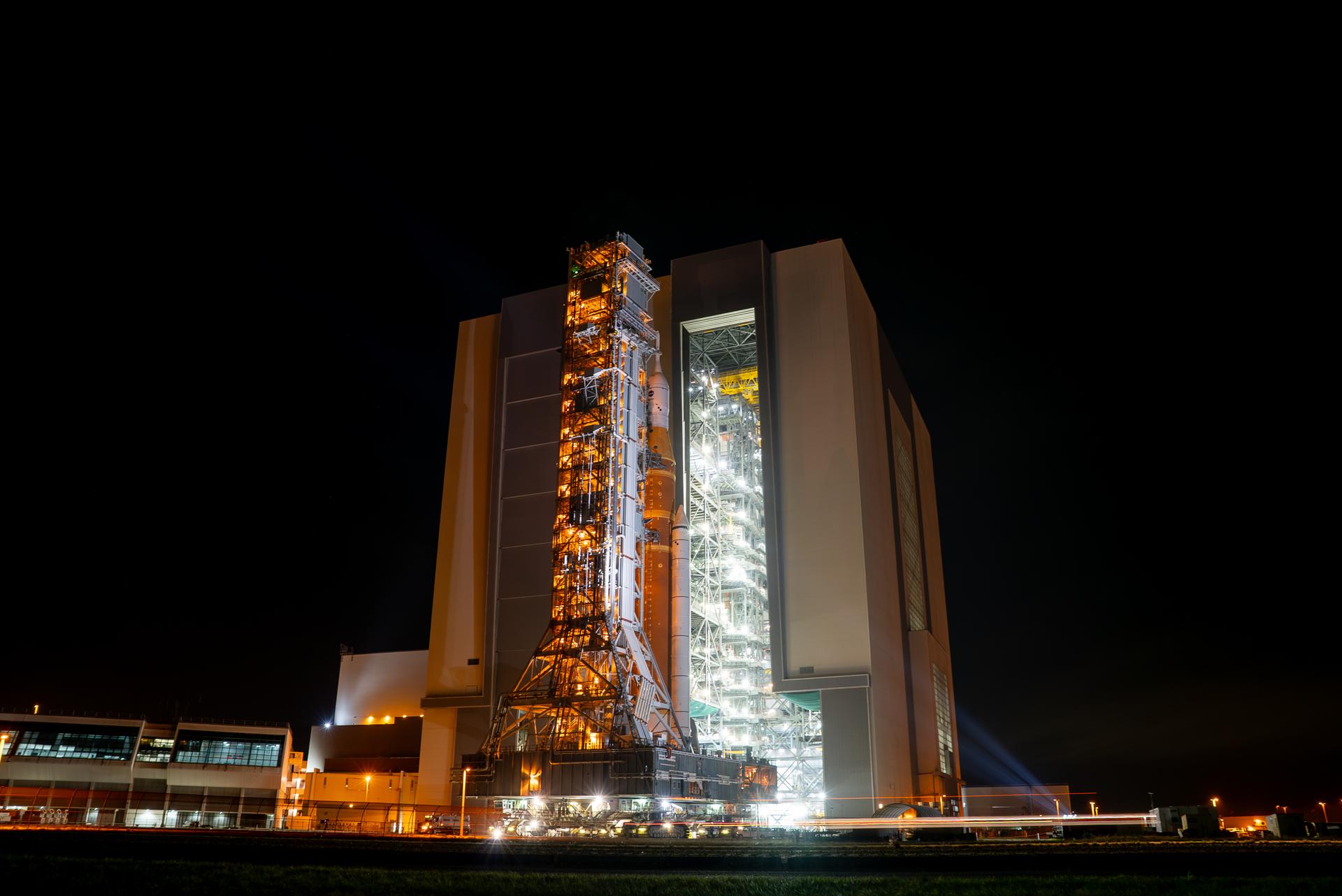 This image shows NASA’s SLS (Space Launch System) and Orion spacecraft rolling out of the Vehicle Assembly Building at NASA’s Kennedy Space Center. NASA's massive Crawler-Transporter, upgraded for the Artemis program, carries the powerful SLS rocket and Orion spacecraft on the Mobile Launcher from the Vehicle Assembly Building to Launch Pad 39B at Kennedy Space Center in preparation for the Artemis II mission. 